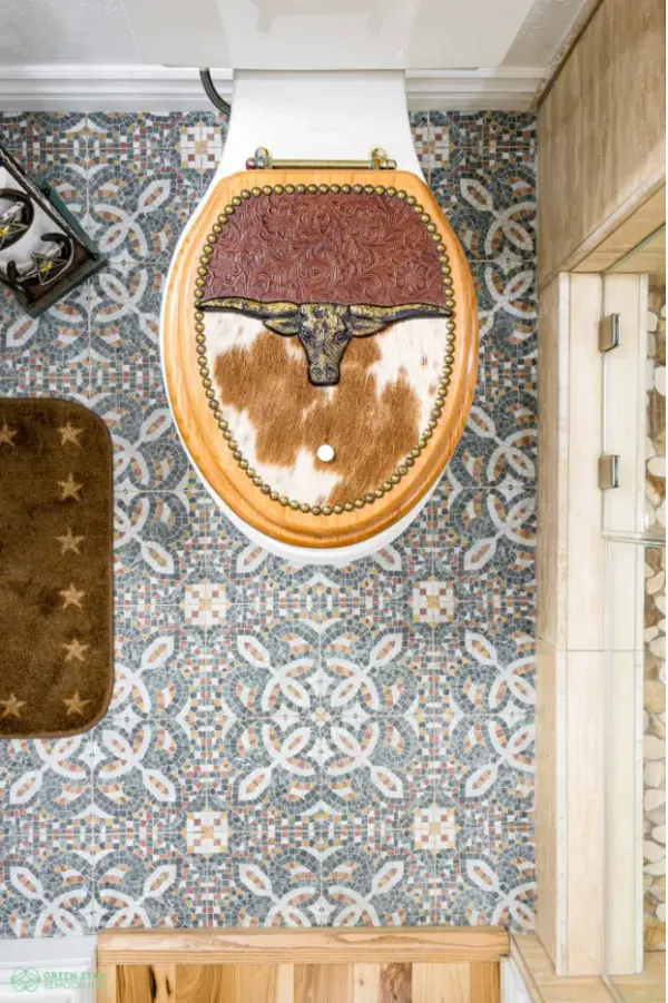 Top-down view of a bathroom remodel featuring a custom wooden toilet seat with tooled leather and cowhide detailing, completed by Green Star Remodeling in Calabasas.