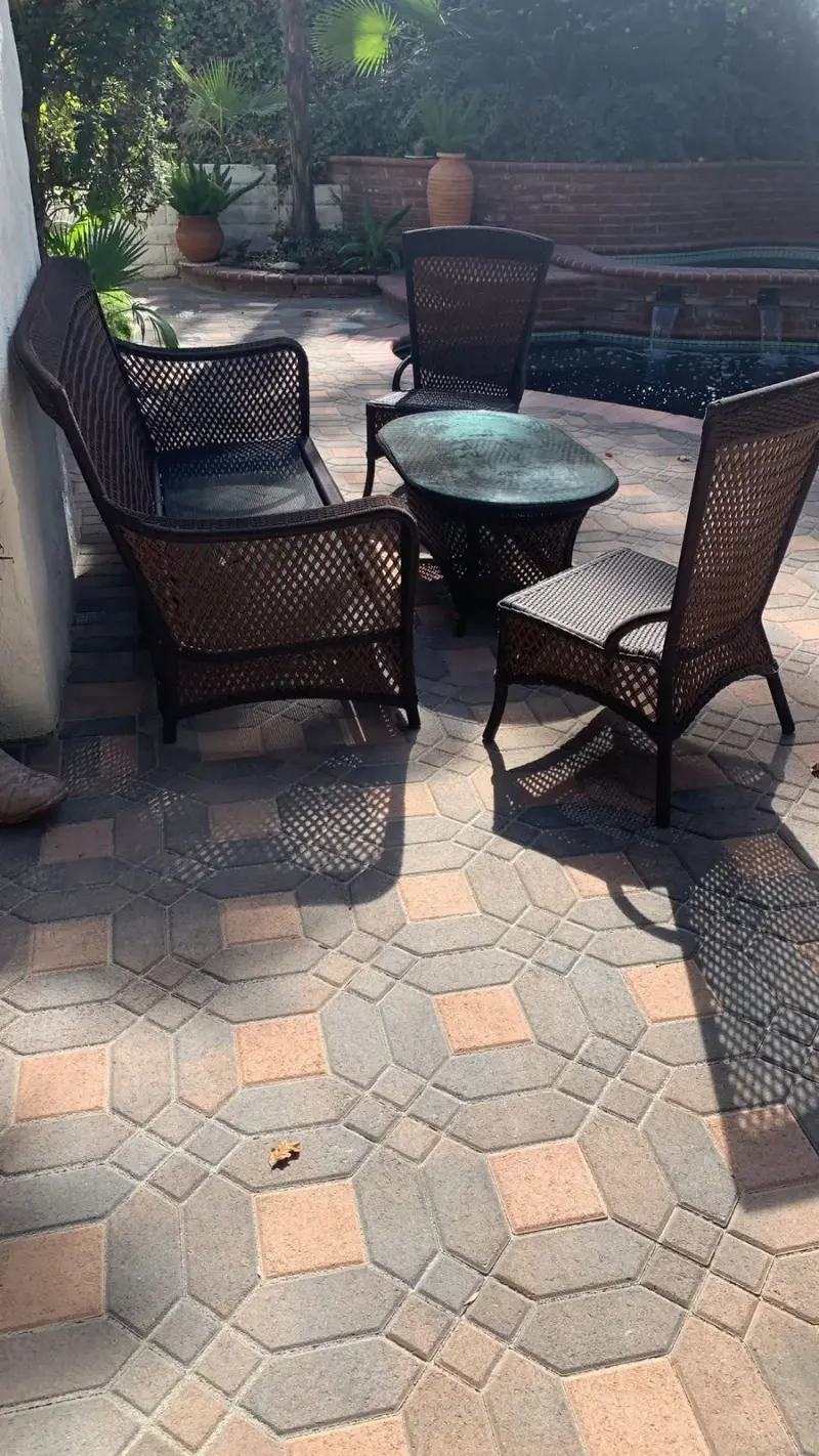 Brown wicker patio furniture set on a paver pool deck in Calabasas.
