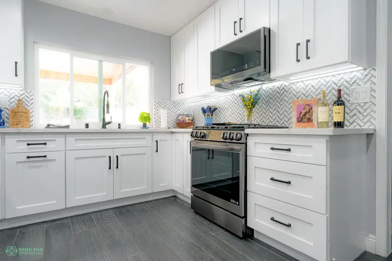 White kitchen remodel with a herringbone tile backsplash in Santa Clarita.
